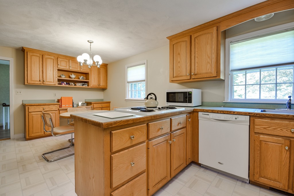 18 Griscom Road Sudbury, MA 01776 - Photo 8 of 29 a kitchen with granite countertop a sink stove and cabinets