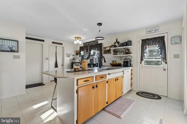 a kitchen with stainless steel appliances a sink and a refrigerator