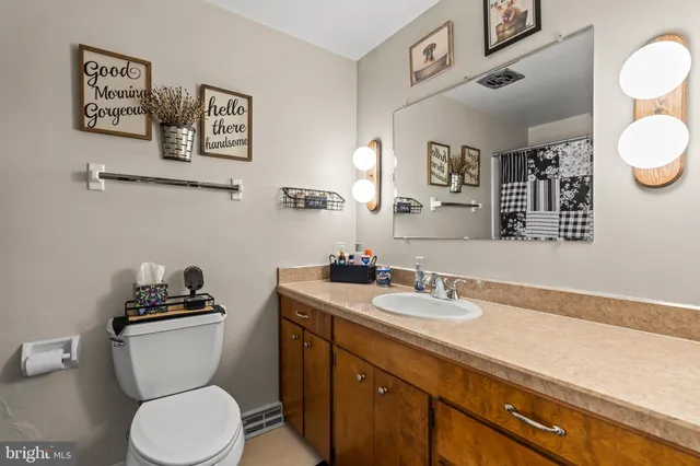 a bed sitting in a bedroom next to a window and a larger closet