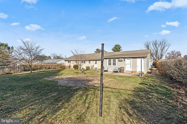 a backyard of a house with table and chairs