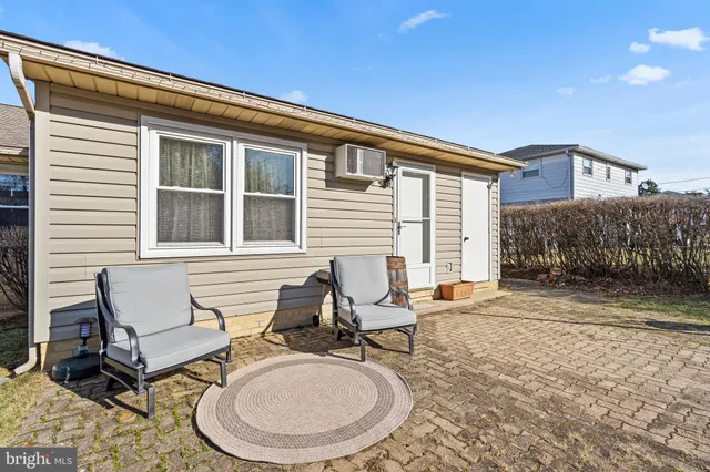 a backyard of a house with table and chairs