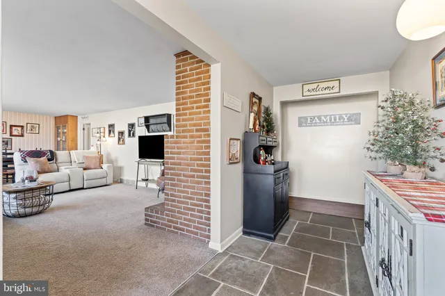 a view of a hallway to a livingroom with furniture