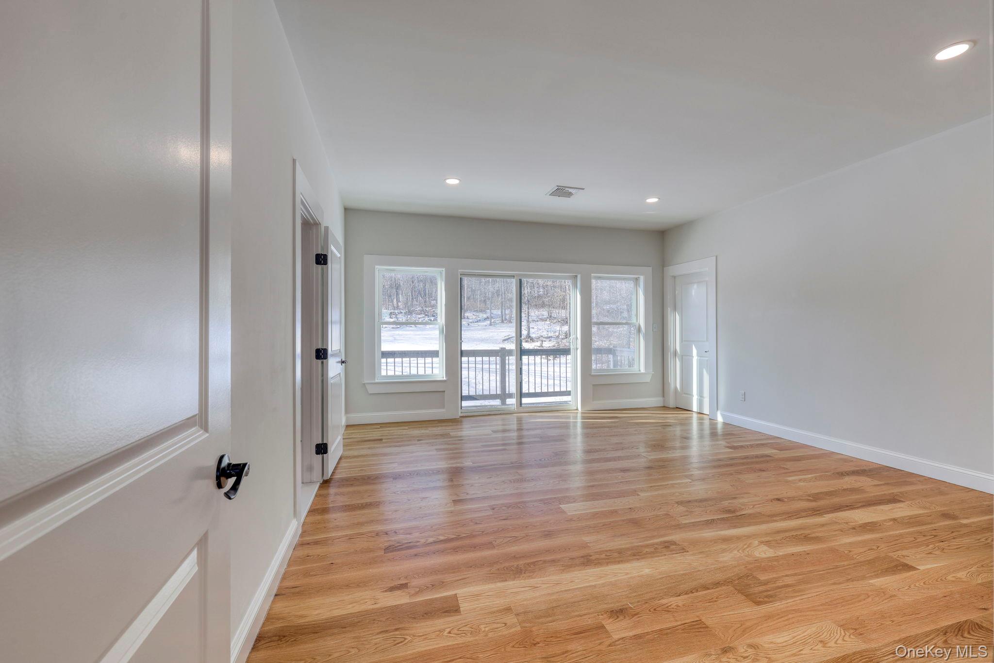 133 West Mombasha Road Monroe, NY 10950 - Photo 14 of 42 a view of an empty room with wooden floor and a window