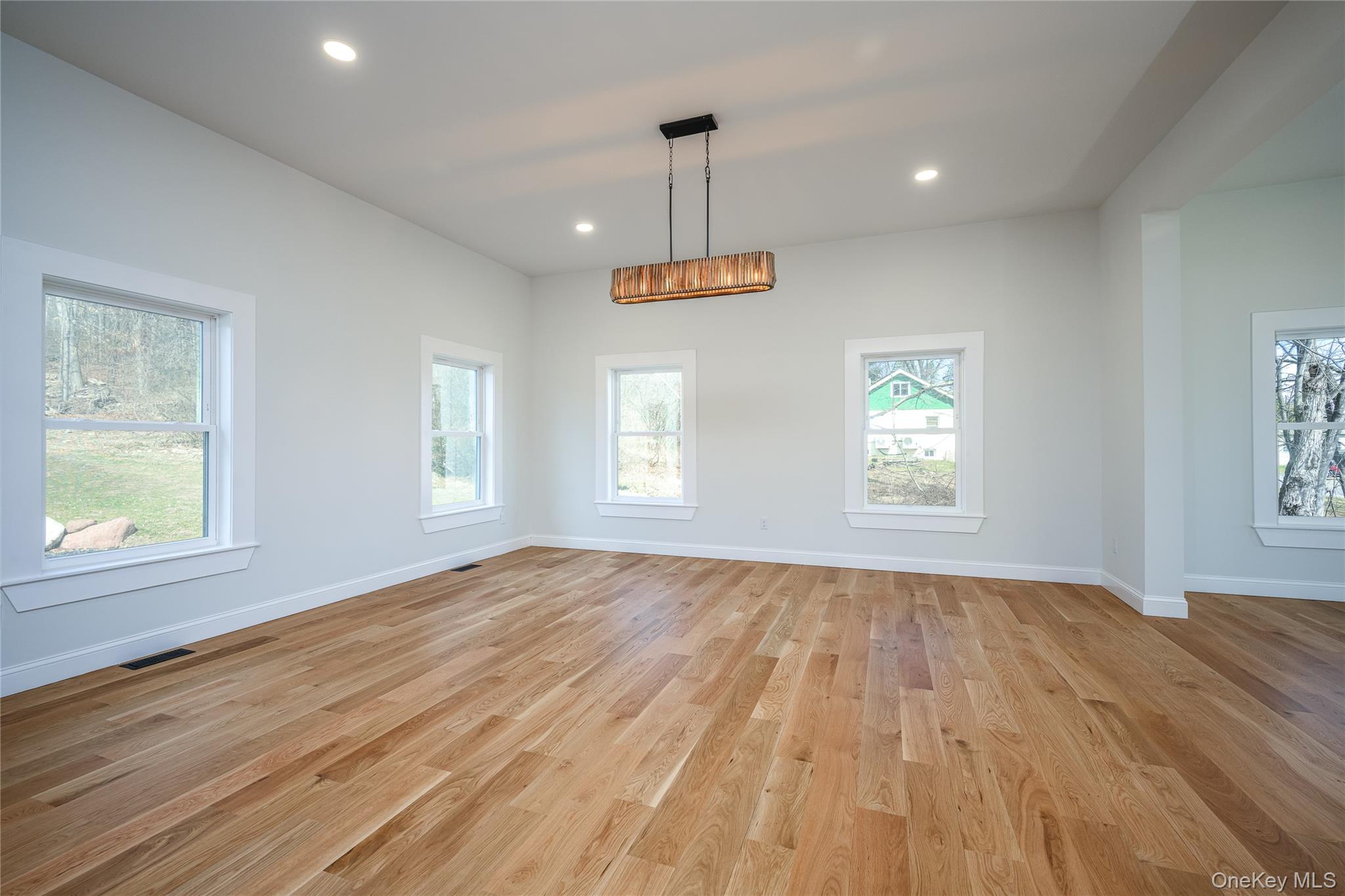 133 West Mombasha Road Monroe, NY 10950 - Photo 16 of 41 an empty room with wooden floor windows and ceiling fan