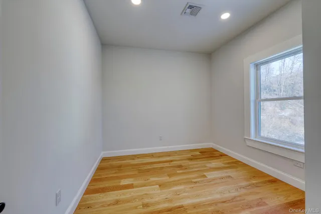 a view of a room with of a air conditioner and window