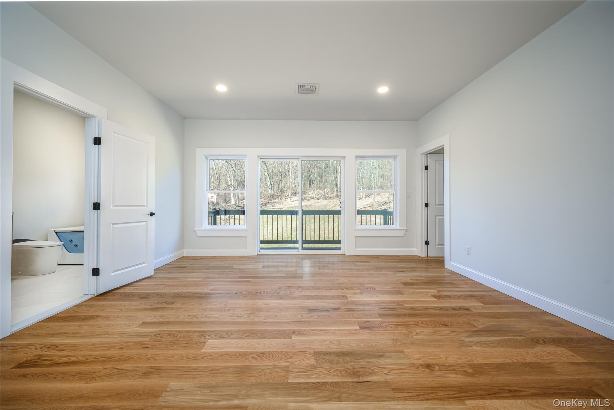 133 West Mombasha Road Monroe, NY 10950 - Photo 25 of 41 a view of an empty room with wooden floor and a window