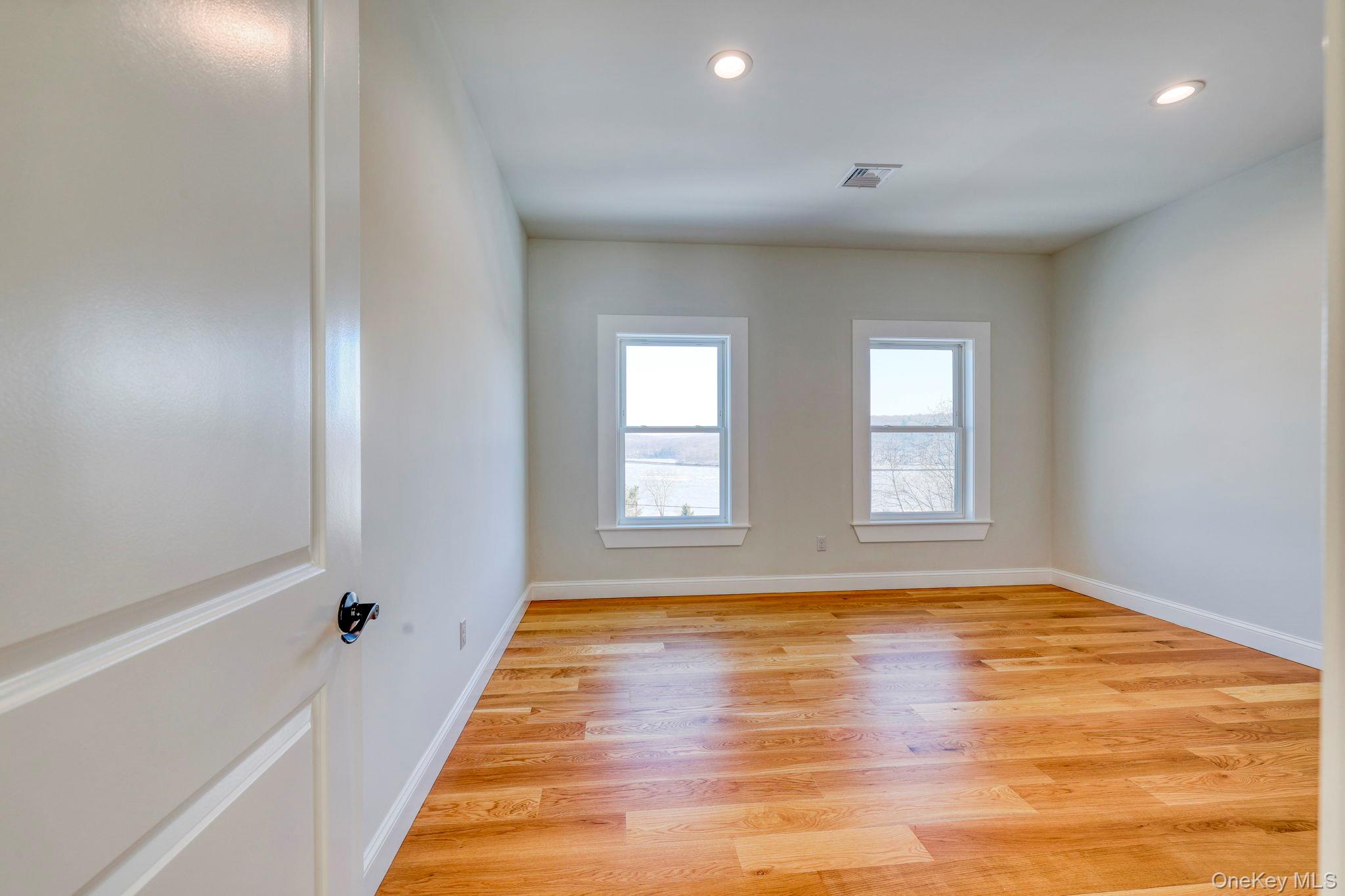 133 West Mombasha Road Monroe, NY 10950 - Photo 26 of 42 a view of an empty room with window and wooden floor