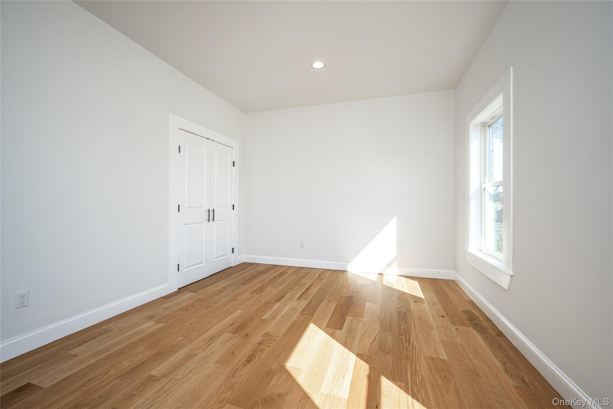 133 West Mombasha Road Monroe, NY 10950 - Photo 33 of 41 an empty room with wooden floor and windows