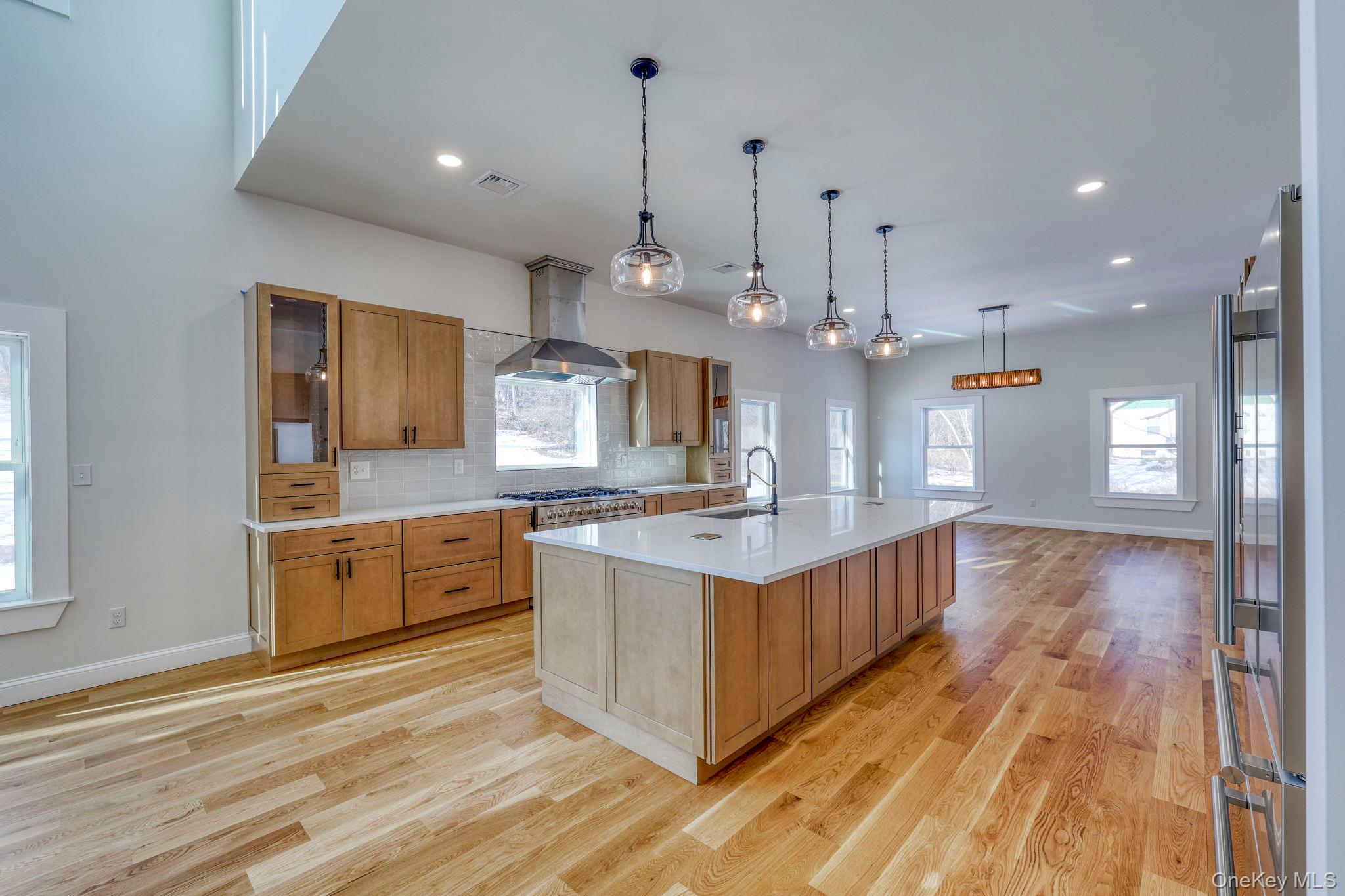 133 West Mombasha Road Monroe, NY 10950 - Photo 4 of 42 a large kitchen with kitchen island white cabinets and chandelier