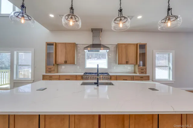 a large kitchen with granite countertop a sink a window and stainless steel appliances