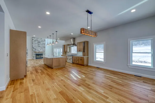 a view of a kitchen with a sink stainless steel appliances and cabinets