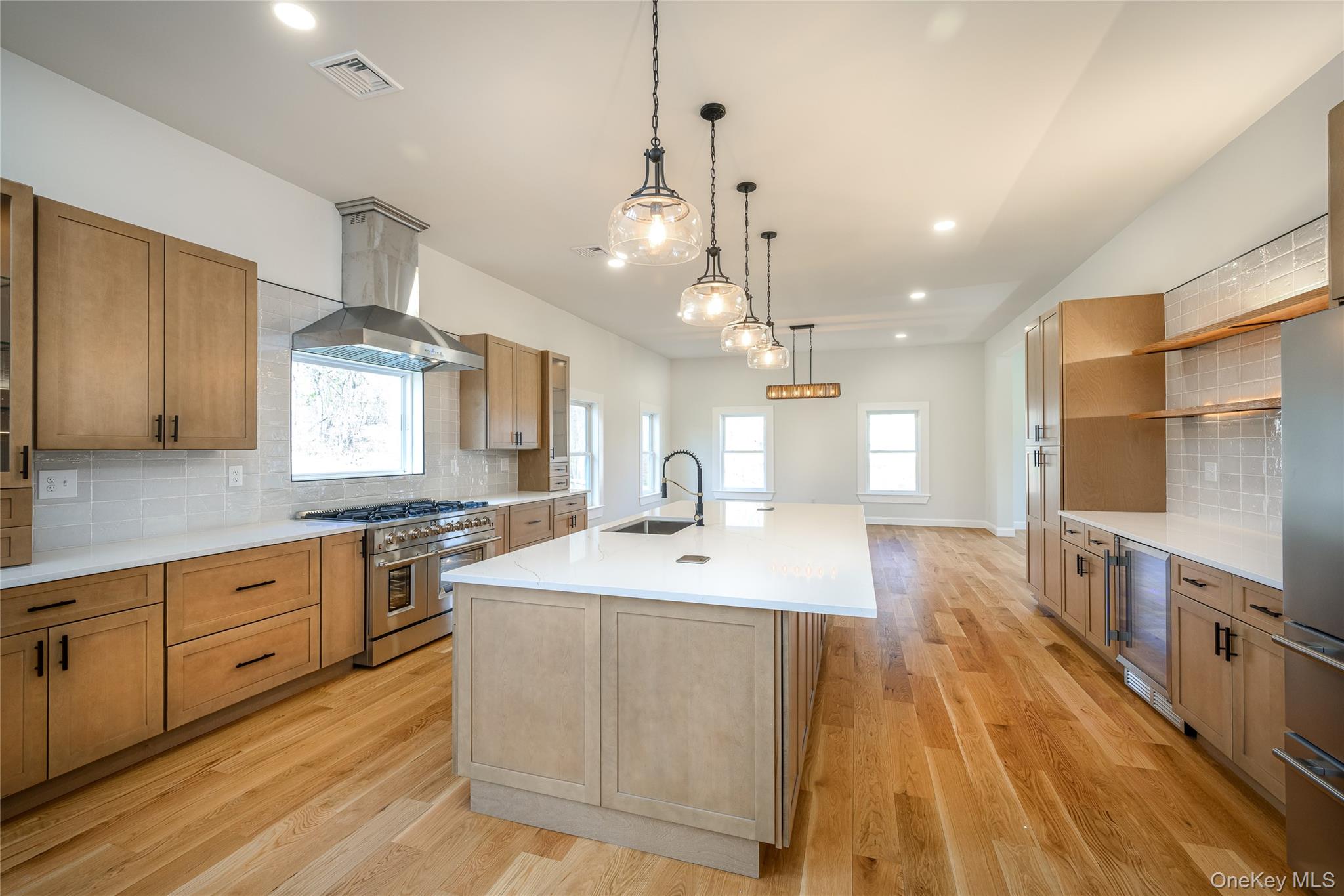 133 West Mombasha Road Monroe, NY 10950 - Photo 10 of 41 a large kitchen with stainless steel appliances a lot of counter space and a wooden floors