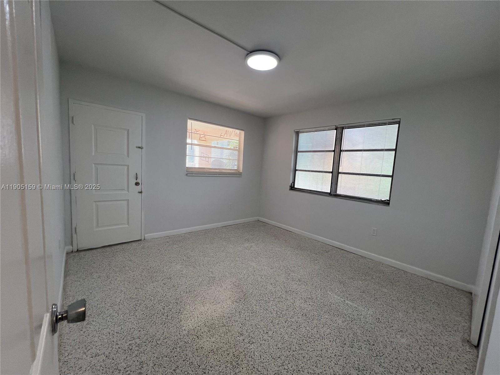 675 Southwest 7th Avenue, Unit 7 Miami, FL 33130 - Photo 14 of 16 an empty room with windows and closet