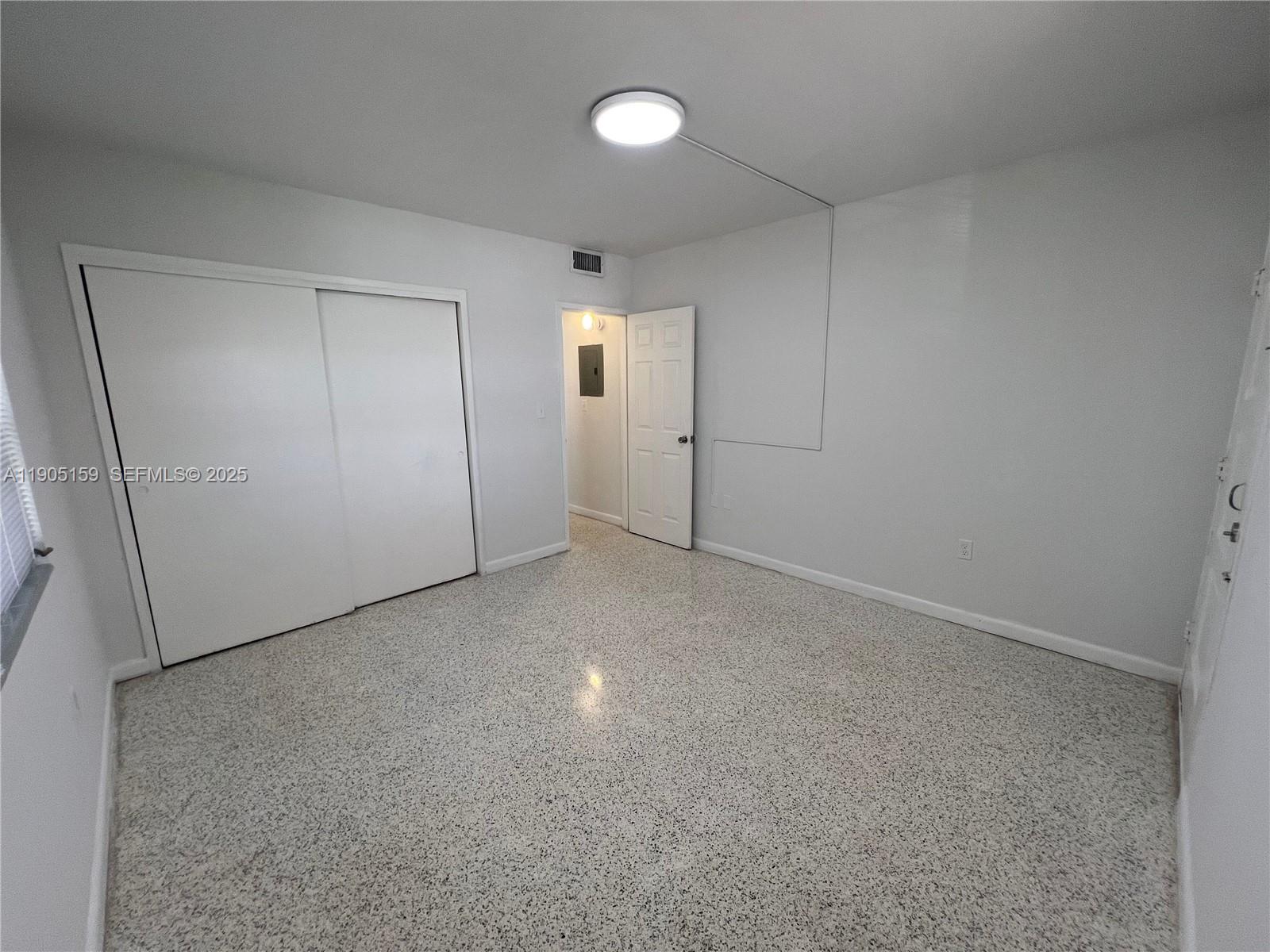 675 Southwest 7th Avenue, Unit 7 Miami, FL 33130 - Photo 15 of 16 an empty room with closet and mirror