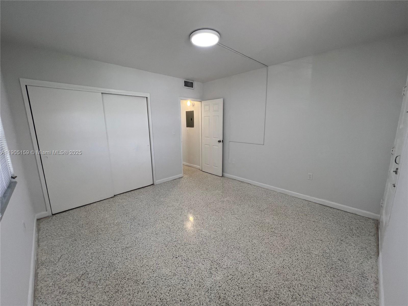 675 Southwest 7th Avenue, Unit 7 Miami, FL 33130 - Photo 15 of 16 an empty room with closet and mirror