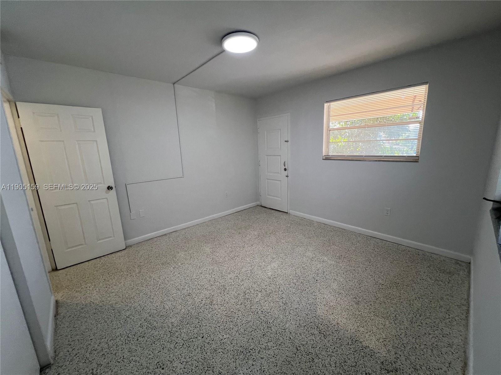 675 Southwest 7th Avenue, Unit 7 Miami, FL 33130 - Photo 16 of 16 a view of an empty room with a window