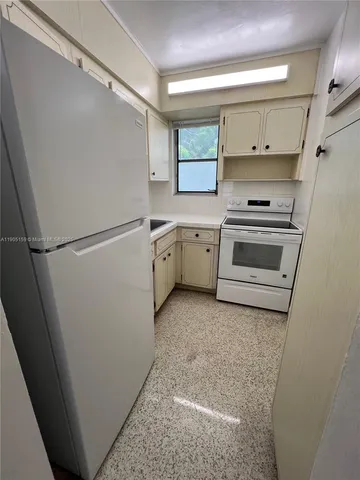 a view of cabinets and wooden floor