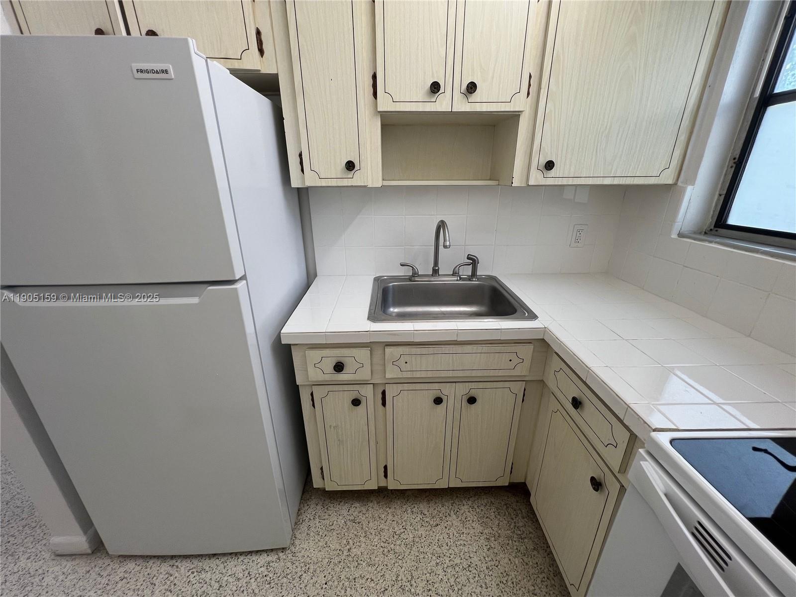 675 Southwest 7th Avenue, Unit 7 Miami, FL 33130 - Photo 7 of 16 a view of cabinets and wooden floor