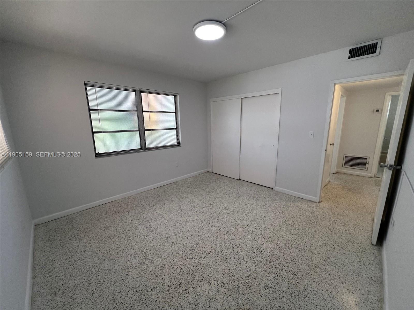 675 Southwest 7th Avenue, Unit 7 Miami, FL 33130 - Photo 9 of 16 an empty room with windows and closet