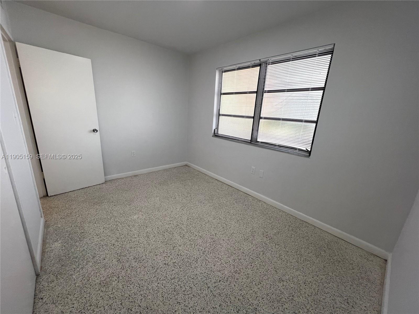 675 Southwest 7th Avenue, Unit 7 Miami, FL 33130 - Photo 10 of 16 an empty room with a window