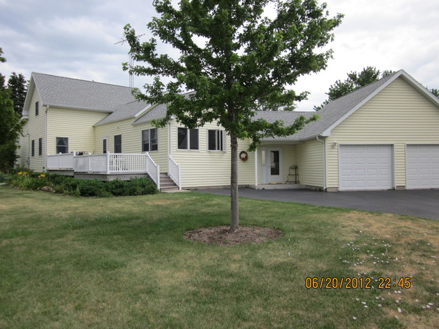 18444 University Road Malta, IL 60150 - Photo 2 of 25 a view of a house with a back yard