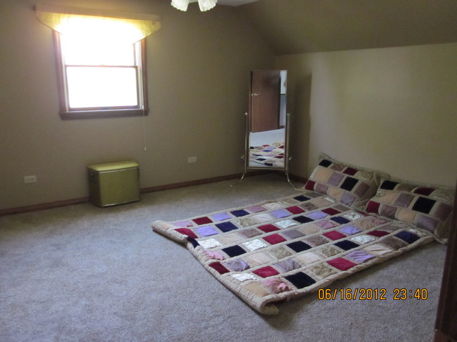 18444 University Road Malta, IL 60150 - Photo 11 of 25 a bedroom with a bed and window