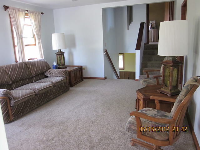 18444 University Road Malta, IL 60150 - Photo 13 of 25 a living room with furniture and a lamp