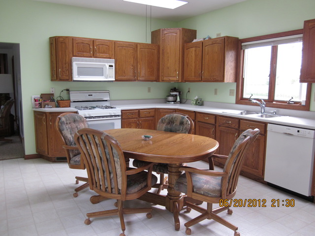 18444 University Road Malta, IL 60150 - Photo 4 of 25 a kitchen with a table chairs sink and cabinets