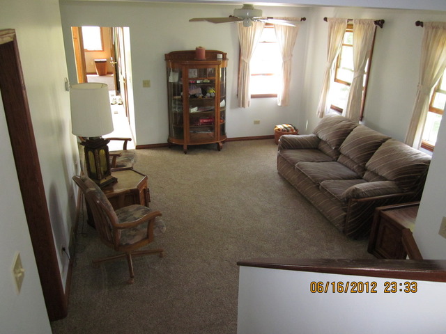 18444 University Road Malta, IL 60150 - Photo 5 of 25 a living room with furniture and a window
