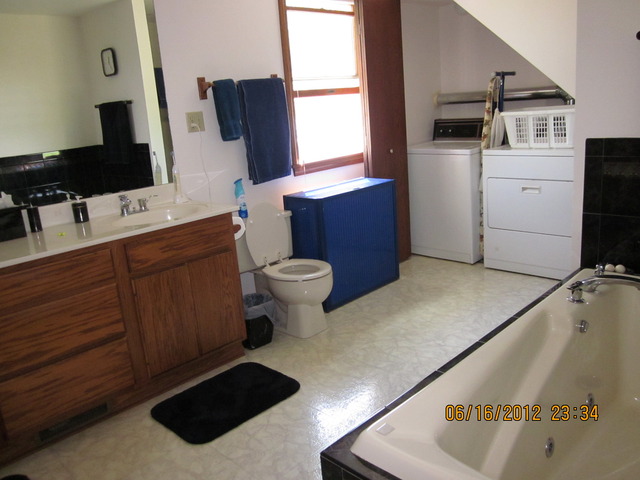 18444 University Road Malta, IL 60150 - Photo 6 of 25 a bathroom with a sink toilet and mirror