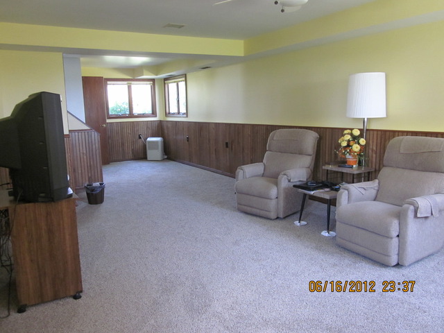 18444 University Road Malta, IL 60150 - Photo 8 of 25 a living room with furniture and a flat screen tv