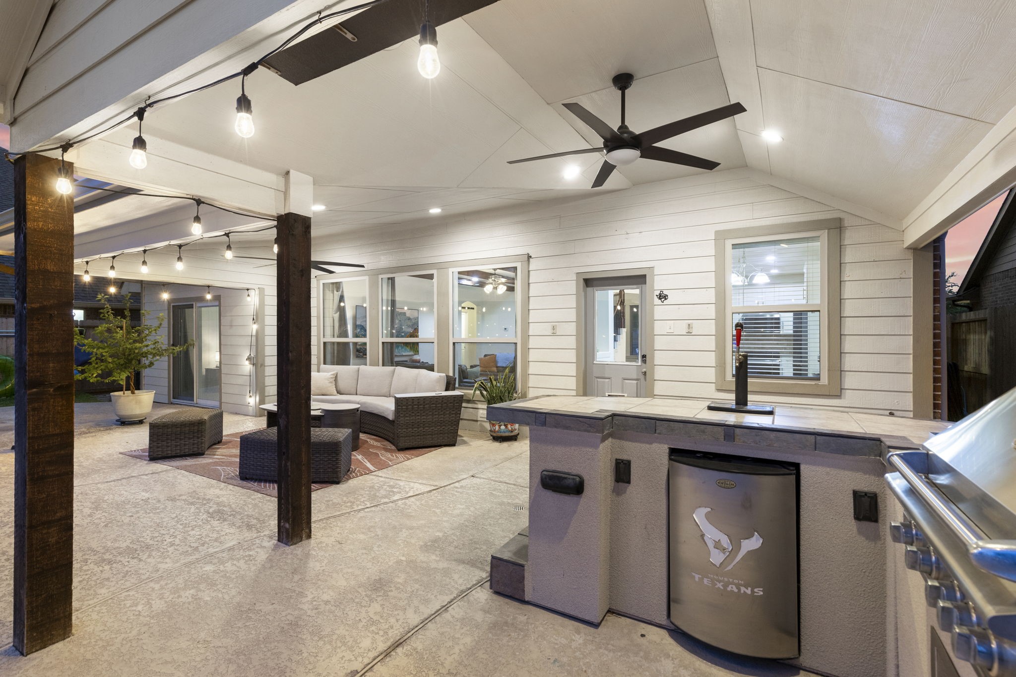 3318 Solvista High Court Spring, TX 77386 - Photo 27 of 33 Outdoor kitchen and bar create the ultimate backyard gathering space, overlooking the sparkling pool beneath a spacious covered patio with vaulted ceilings and cooling fans.