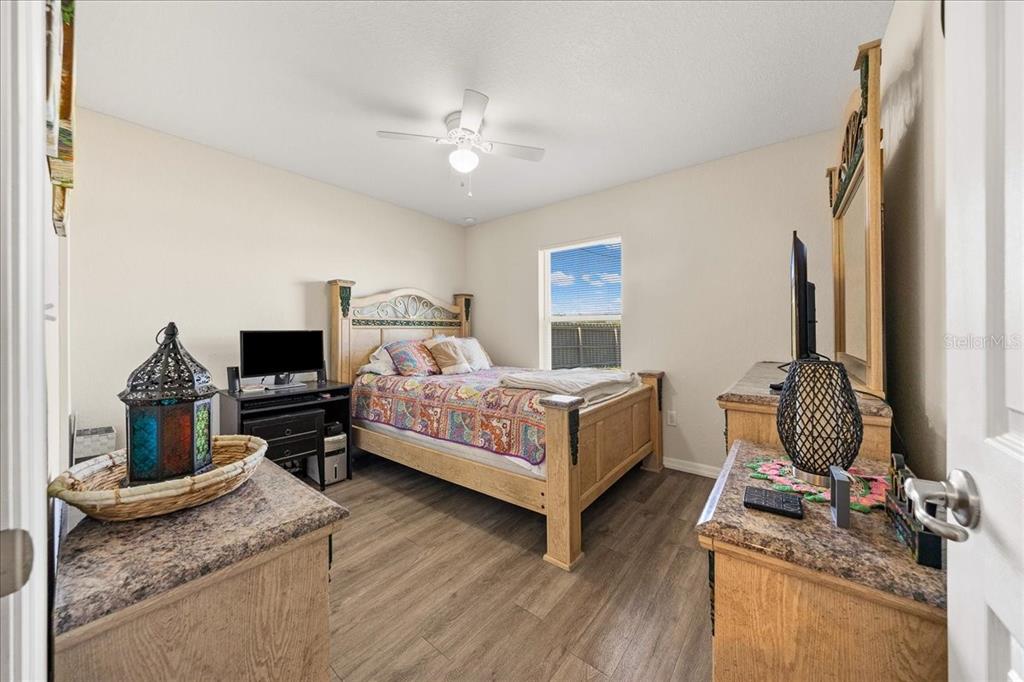 19 Juniper Loop Run Ocala, FL 34480 - Photo 14 of 42 a bedroom with a bed and flat screen tv