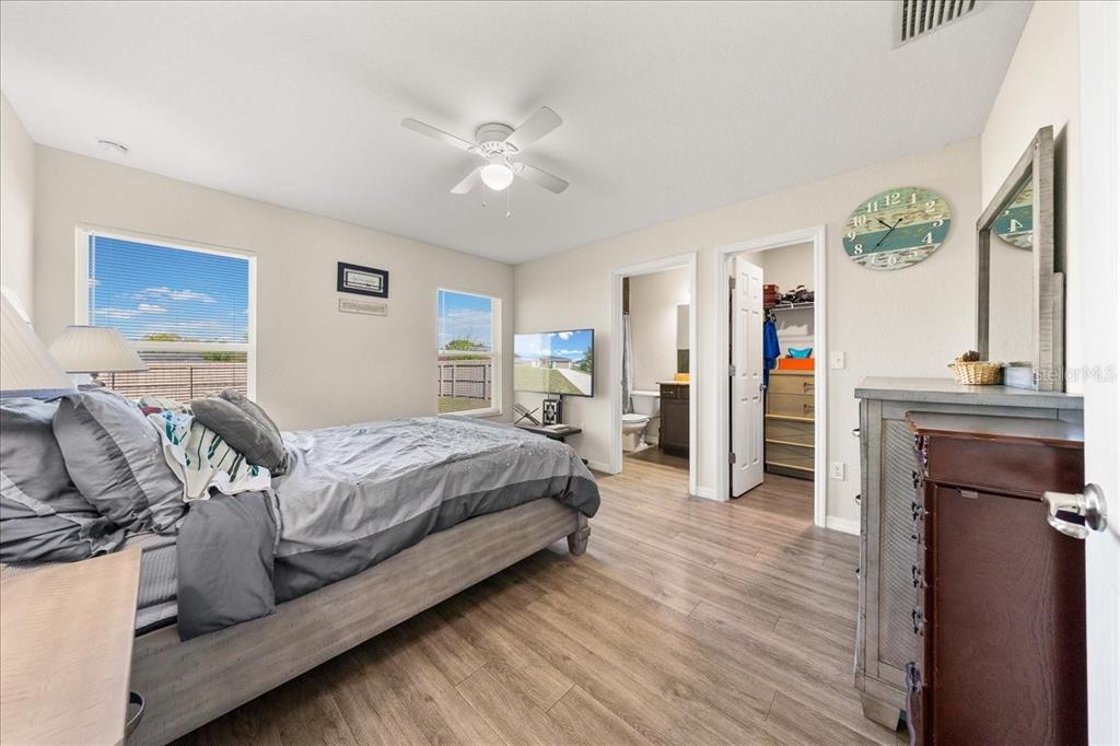 19 Juniper Loop Run Ocala, FL 34480 - Photo 19 of 42 a bedroom with a bed and a chandelier