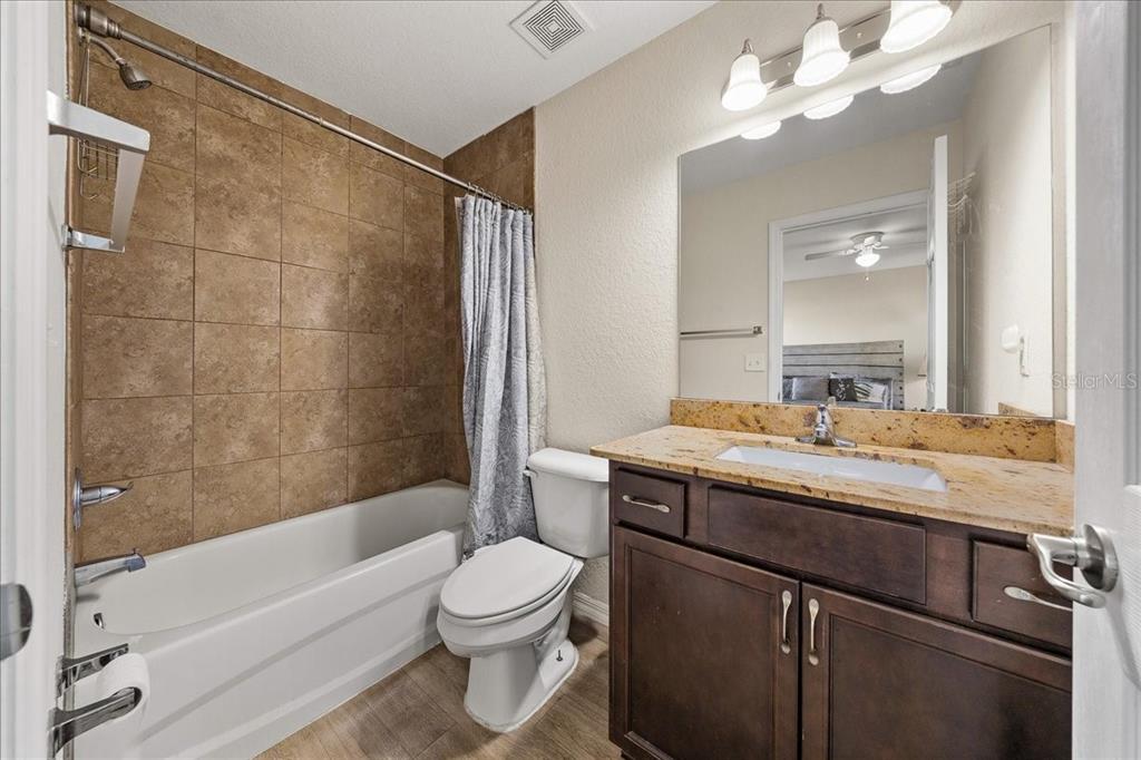 19 Juniper Loop Run Ocala, FL 34480 - Photo 23 of 42 a bathroom with a granite countertop sink a toilet and bathtub