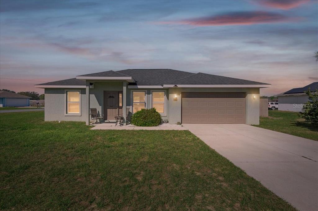 19 Juniper Loop Run Ocala, FL 34480 - Photo 24 of 42 a front view of a house with a yard and garage