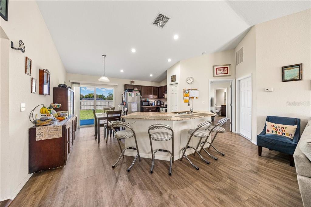 19 Juniper Loop Run Ocala, FL 34480 - Photo 3 of 42 a view of a dining room with furniture and wooden floor