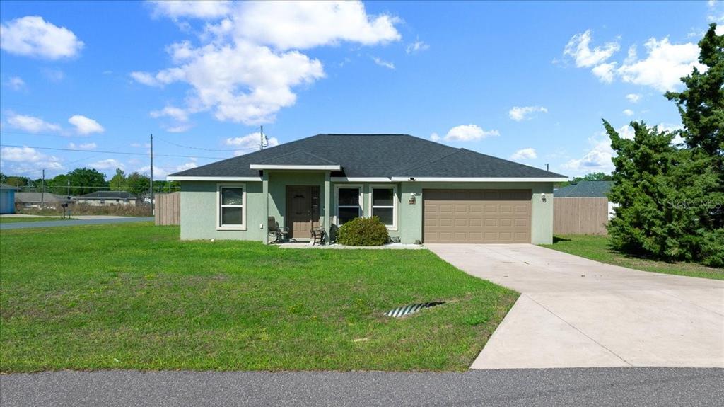 19 Juniper Loop Run Ocala, FL 34480 - Photo 34 of 42 a front view of a house with a yard