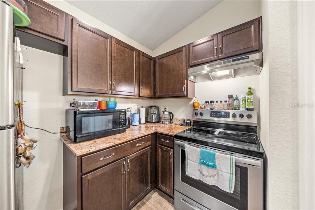19 Juniper Loop Run Ocala, FL 34480 - Photo 10 of 42 a kitchen with stainless steel appliances granite countertop a stove a sink and a refrigerator
