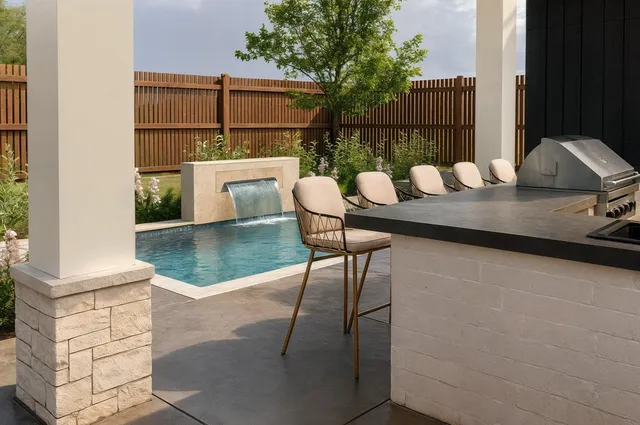 a view of a patio with table and chairs with wooden floor and fence