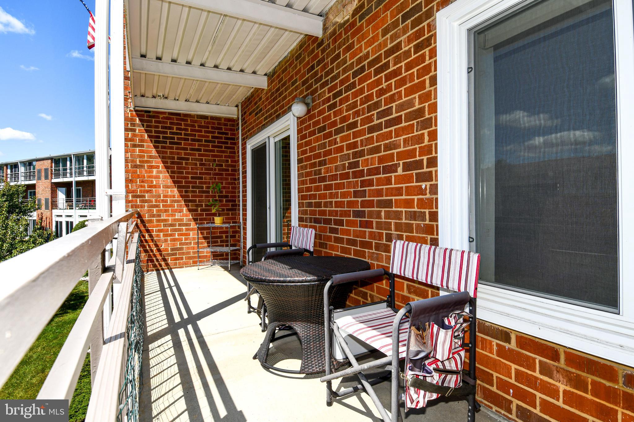 3500 Forest Edge Drive, Unit 152E Silver Spring, MD 20906 - Photo 17 of 33 a balcony with table and chairs