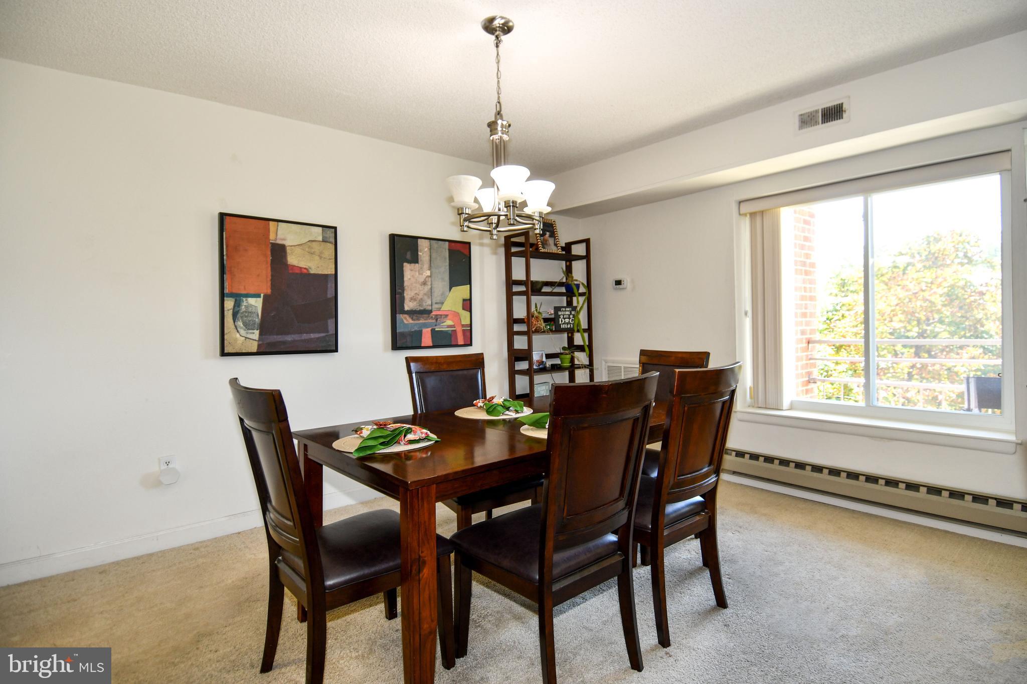 3500 Forest Edge Drive, Unit 152E Silver Spring, MD 20906 - Photo 8 of 33 a view of a dining room with furniture window and outside view