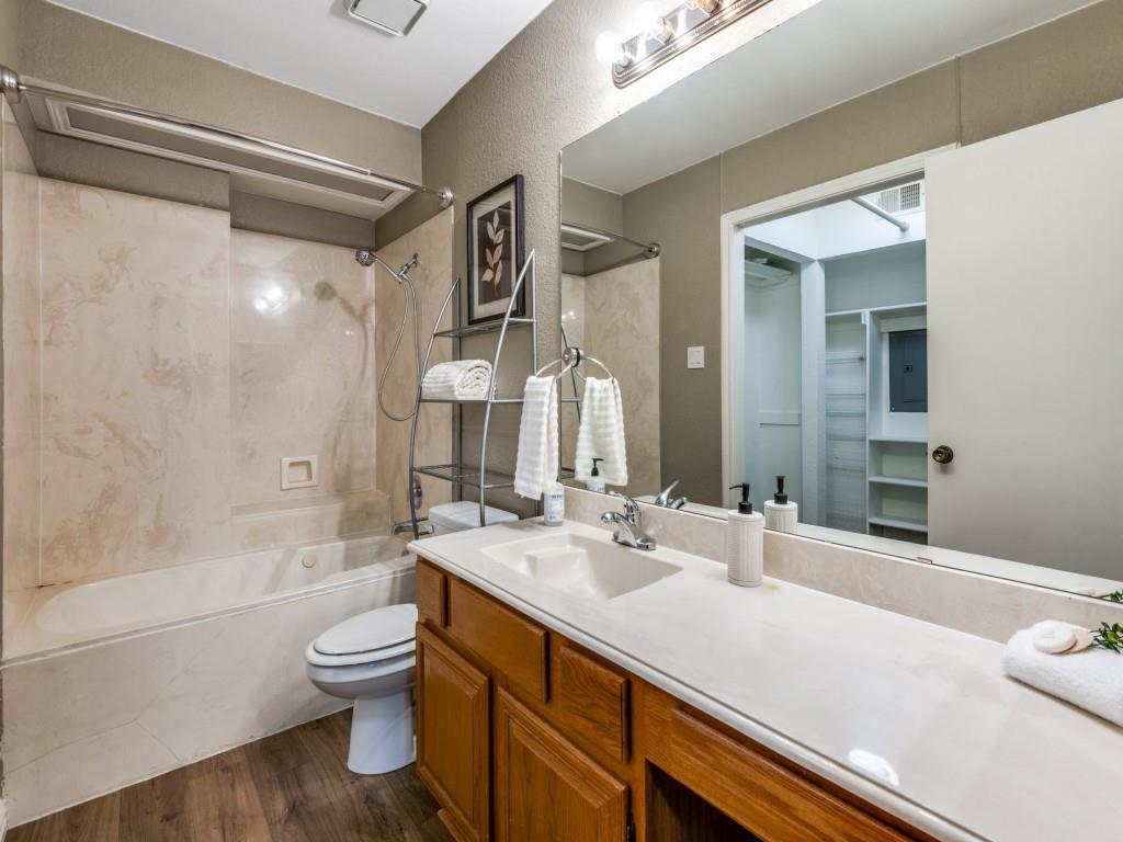 18040 Midway Road, Unit 189 Dallas, TX 75287 - Photo 14 of 28 Bathroom featuring shower / washtub combination, vanity, and dark wood-style floors