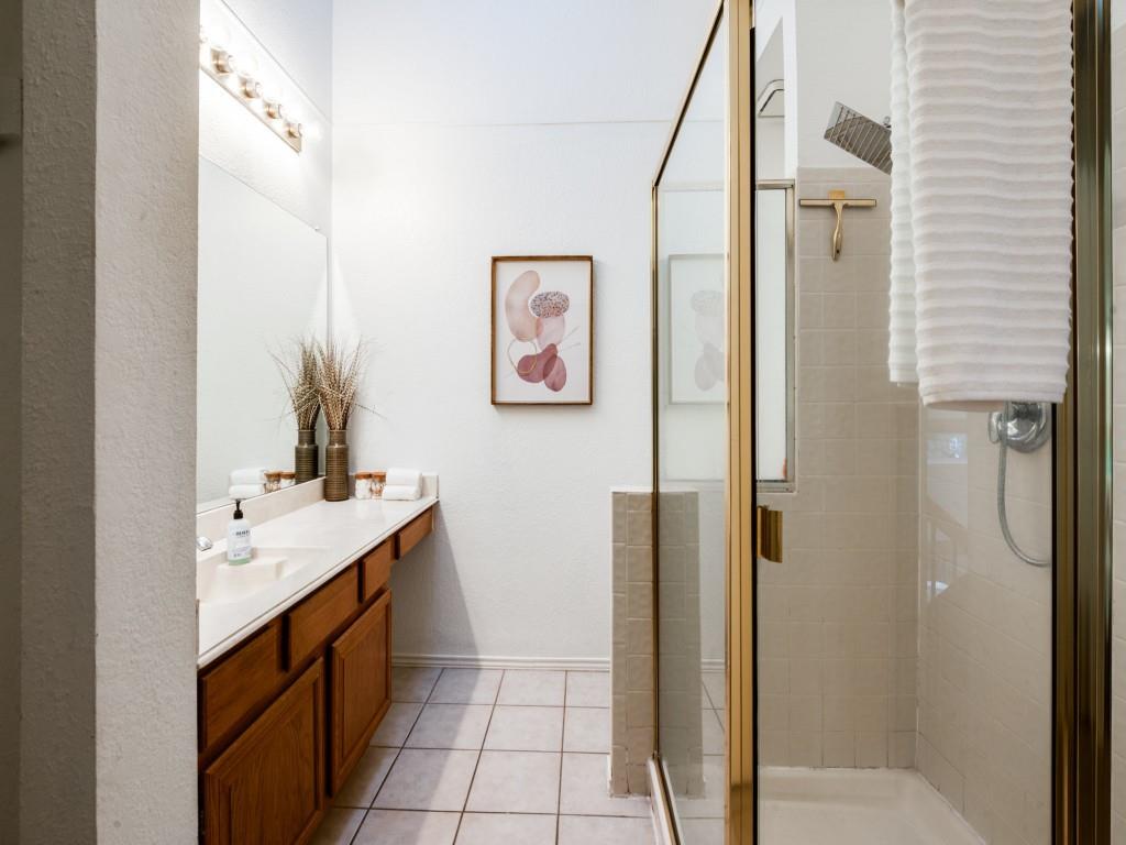 18040 Midway Road, Unit 189 Dallas, TX 75287 - Photo 19 of 28 Full bath with vanity, a shower stall, and light tile patterned flooring