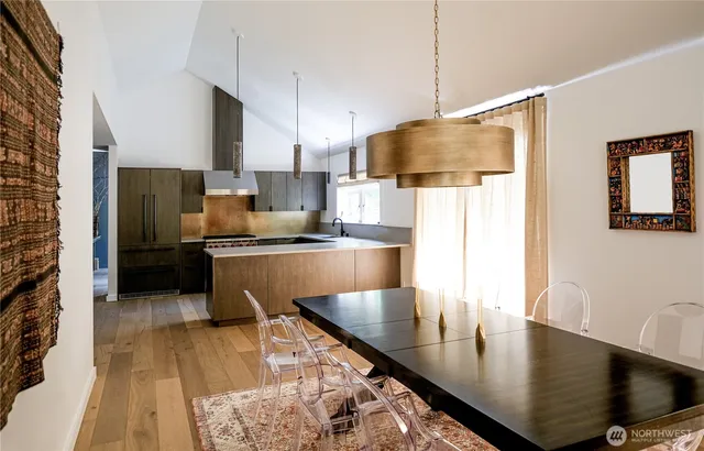 a kitchen with stainless steel appliances granite countertop a sink a stove and a refrigerator