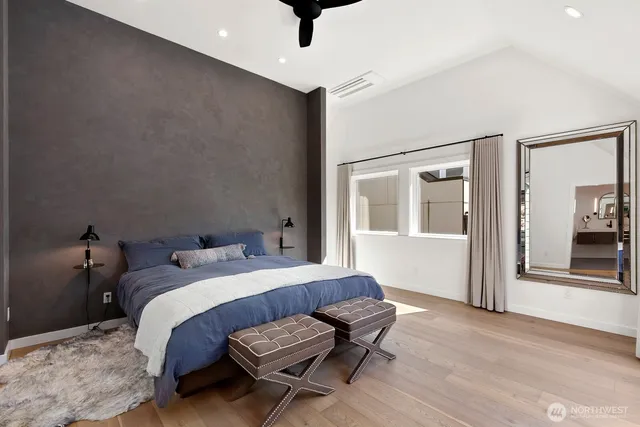 a bedroom with a bed closet and wooden floor