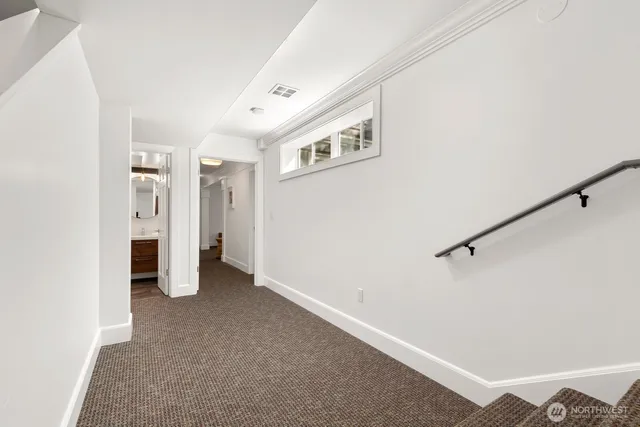 a view of a big room with closet and windows