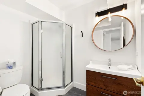 a bathroom with a sink a toilet and a mirror