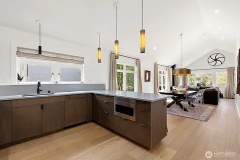 a kitchen with stainless steel appliances granite countertop a stove a sink and a wooden floors