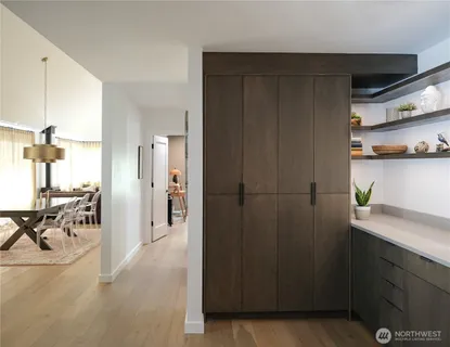 a view of hallway with furniture and a window